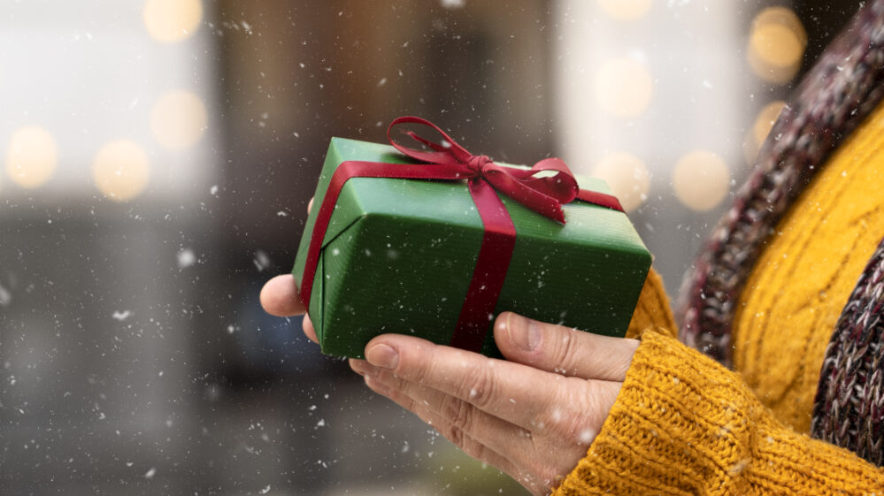 Side view hands holding present